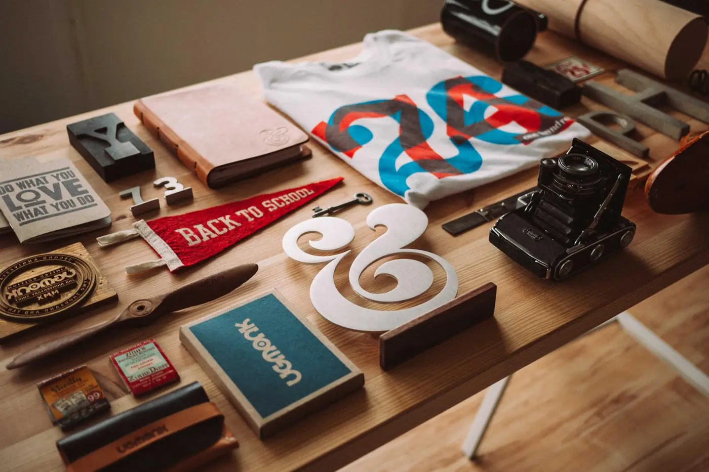 Letterpress blocks, notebooks and printed cards spread on a desk
