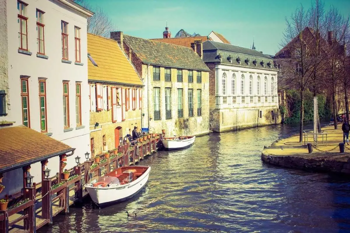Colourful canal-side houses reflected in calm water