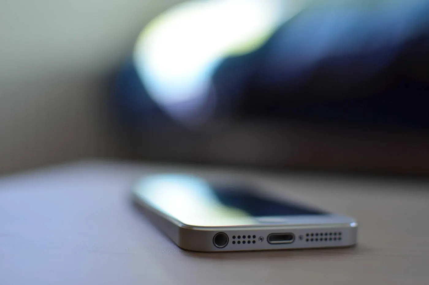Smartphone lying face up on a dark desk