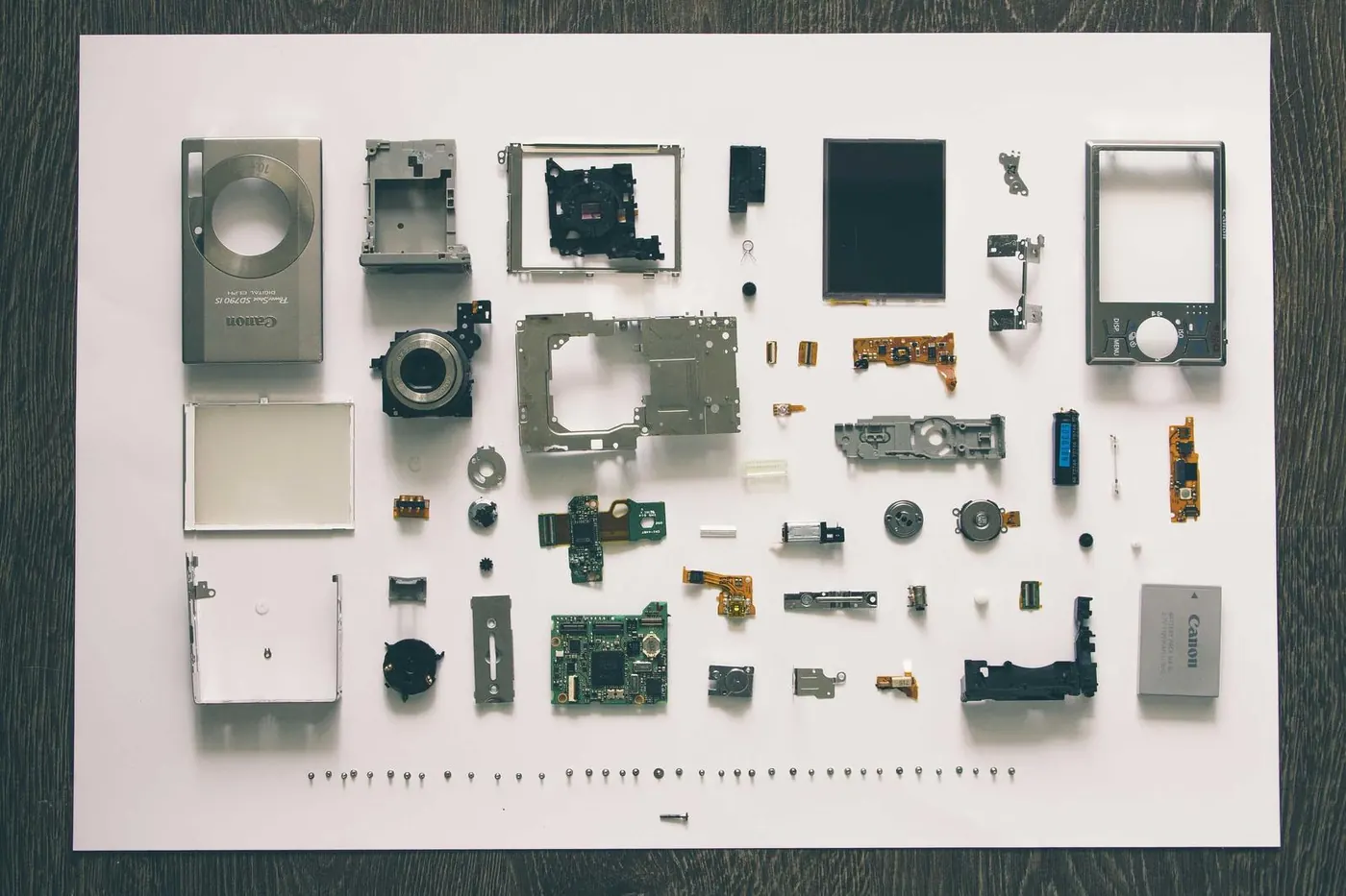 Neat flat lay of headphones, camera and travel gadgets