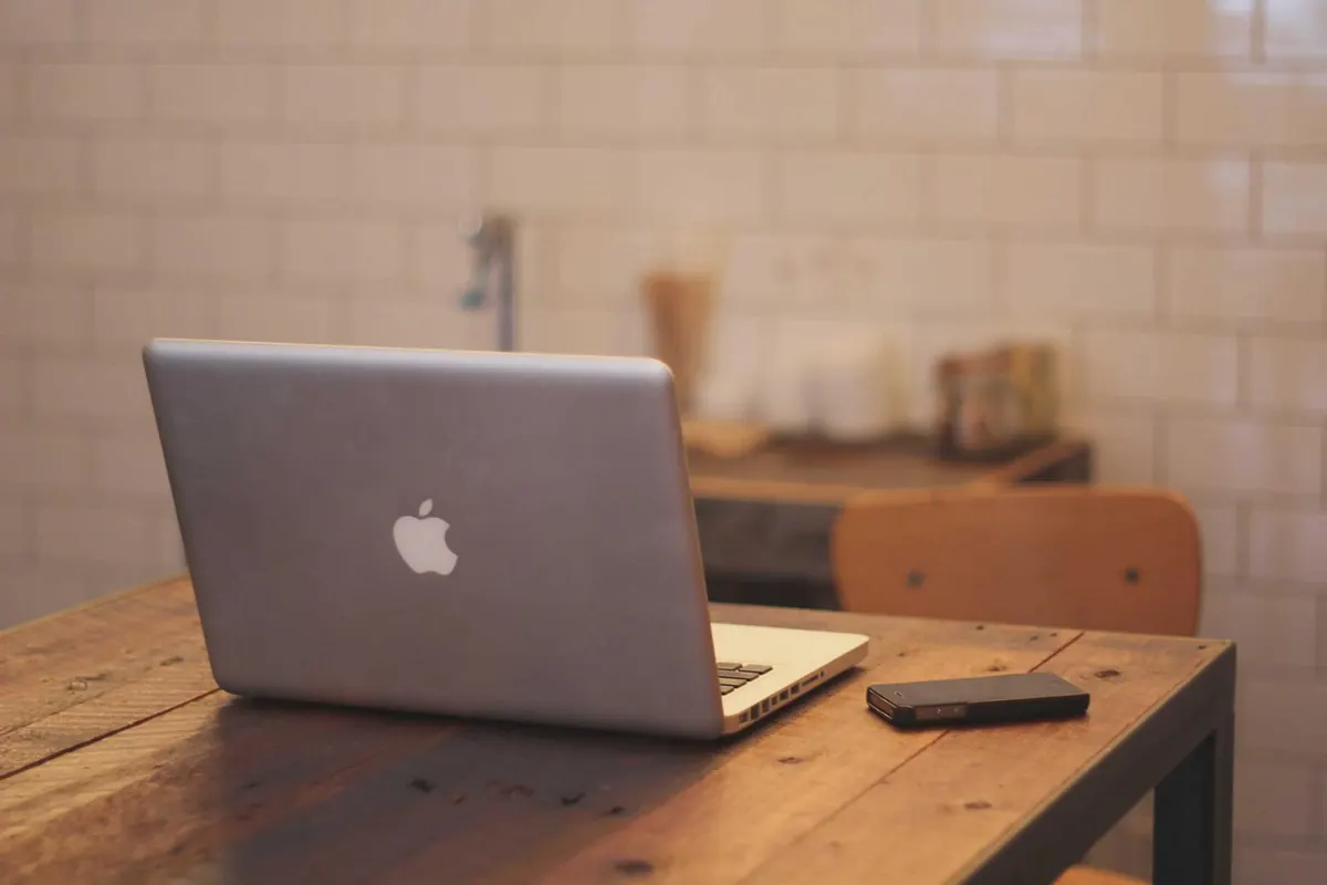 Laptop on a tidy desk showing an online shop layout
