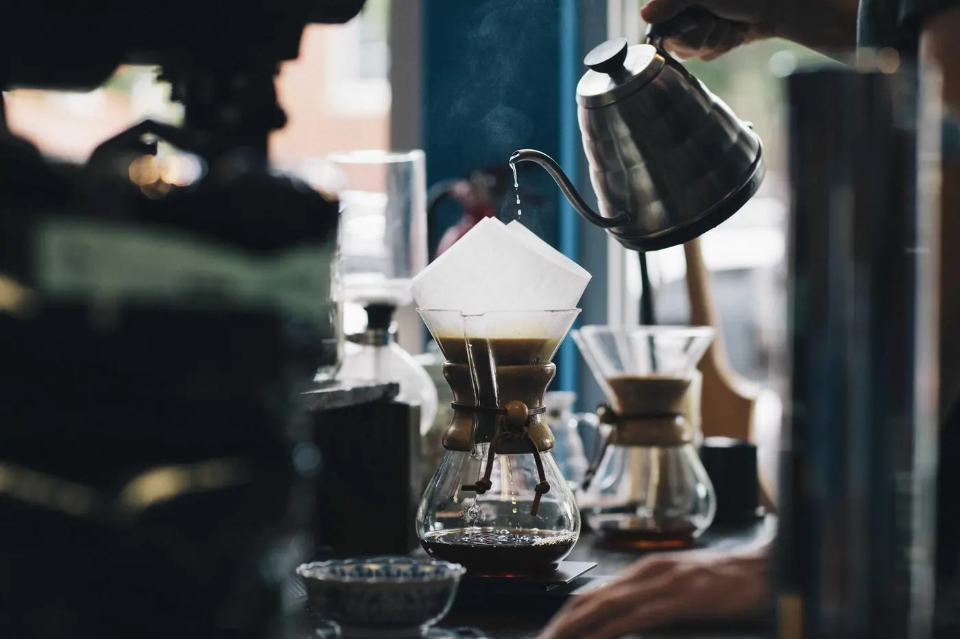 Barista pouring coffee through a filter