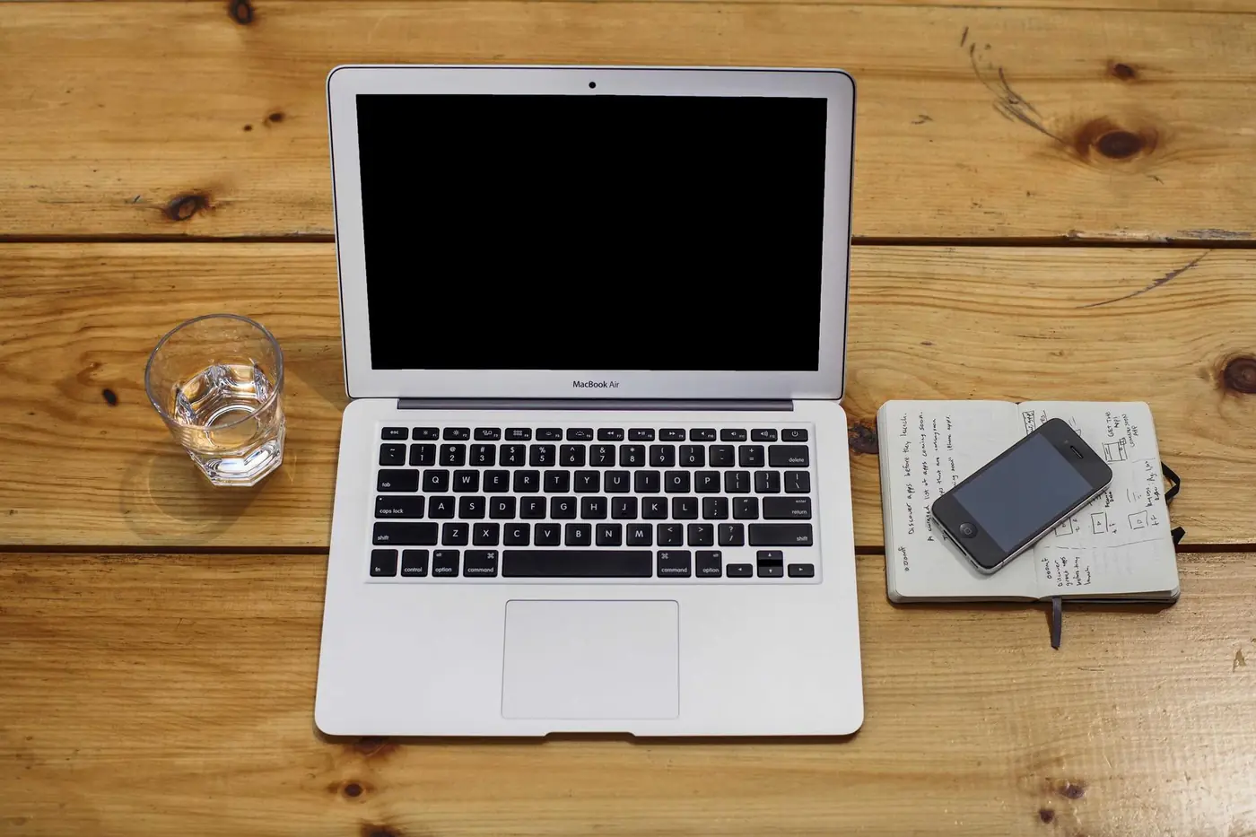 Laptop and phone on a wooden desk