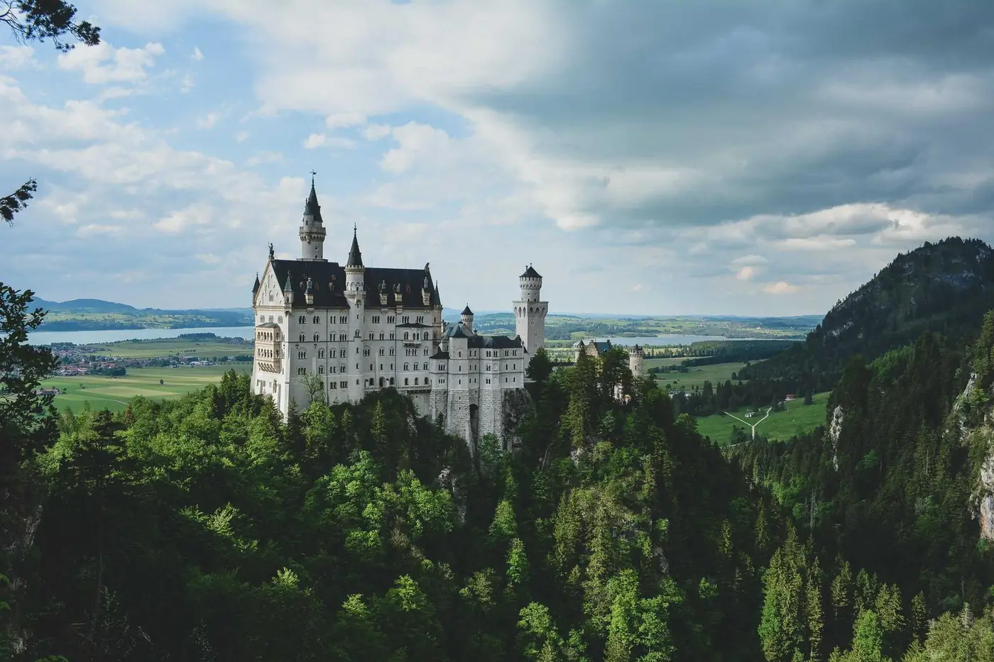 White castle on a forested hillside